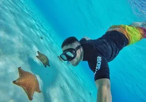 Cozumel by transparent boat and snorkeling in the sky with lunch.