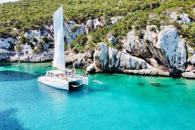 From Alghero: 6-hour catamaran tour in Porto Conte Park